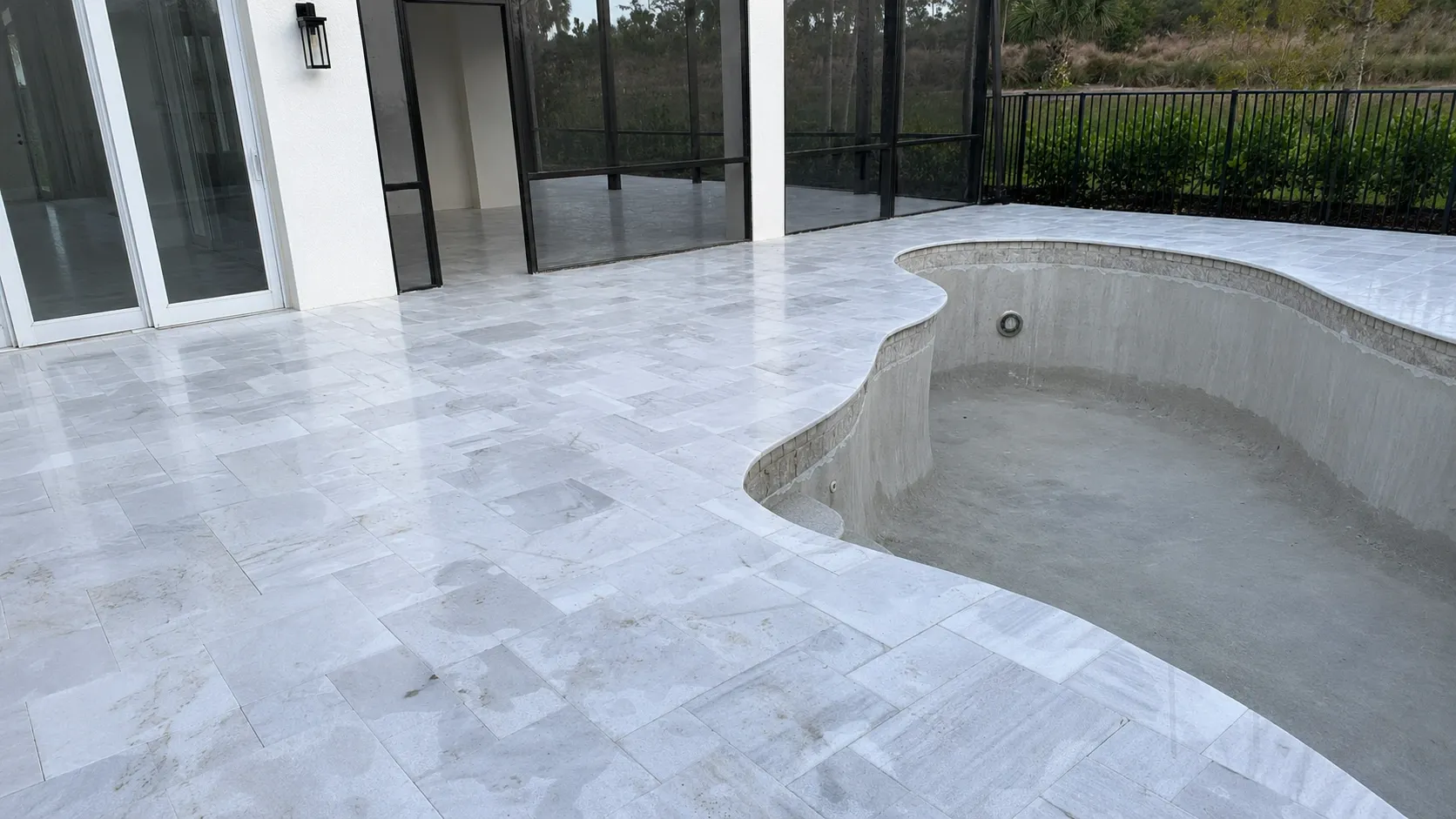 Travertine infinity pool deck in Parkland