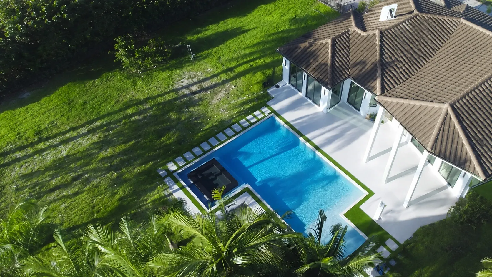 Artificial turf around pool deck in Palm Beach